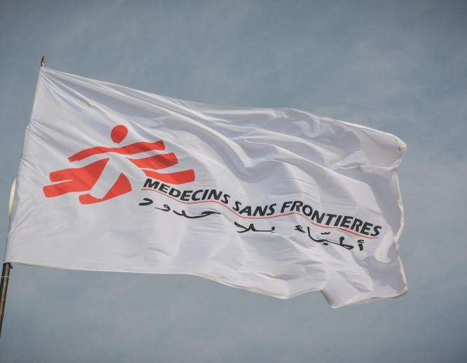 White flag of Doctors Without Borders/Médecins Sans Frontières (MSF) against the sky