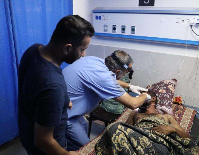 Medical staff treat a patient at Al Shifa Hospital in Gaza