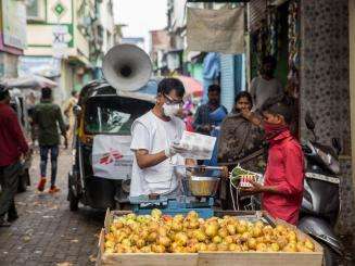 MSF staff Ganpat distributing soap and masks to hawkers on the street