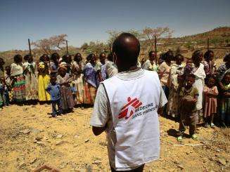 An MSF translator provides information to women and children waiting for a medical consultation at a mobile clinic in the village of Adiftaw, Tigray.