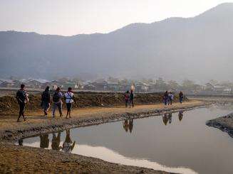 MSF staff on their journey to set up a clinic next to a river.
