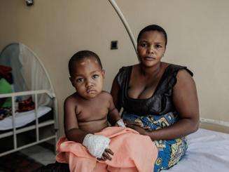 A mother and child sit on a hospital bed at Salama Hospital in Bunia, DR Congo.