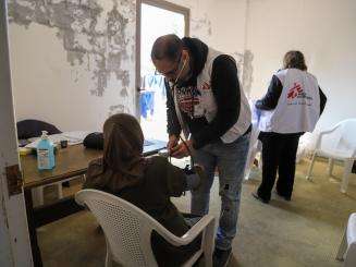 MSF staff in a mobile medical unit treat a woman in Lebanon. 