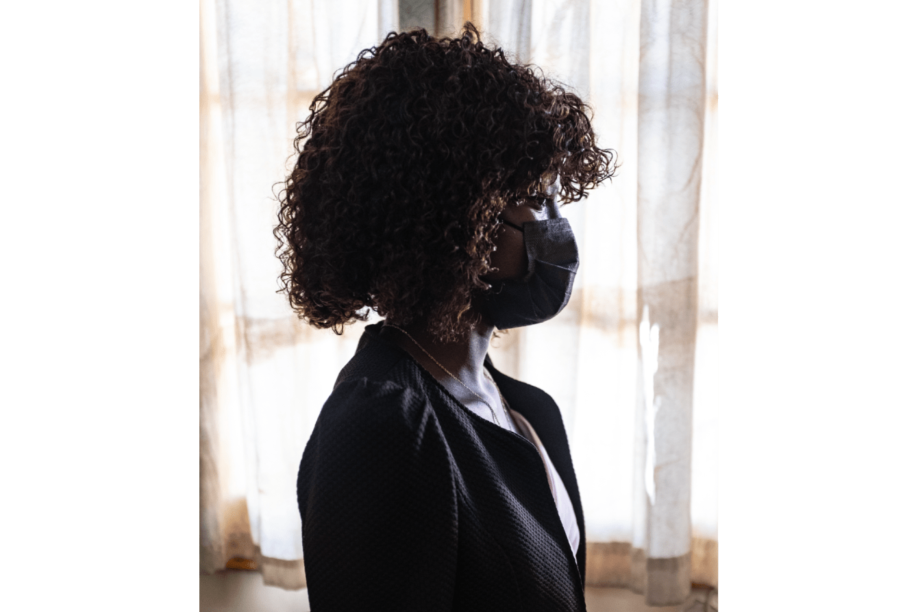 Glória*, 23, stands in the Ponta-gêa health center in Beira, Mozambique.
