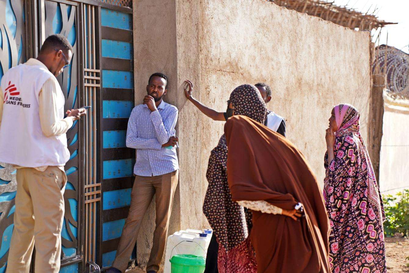 Members of the CATI team waiting to be allowed to enter to one of the households in order to administer the oral cholera vaccines in Jigjiga, Ethiopia.