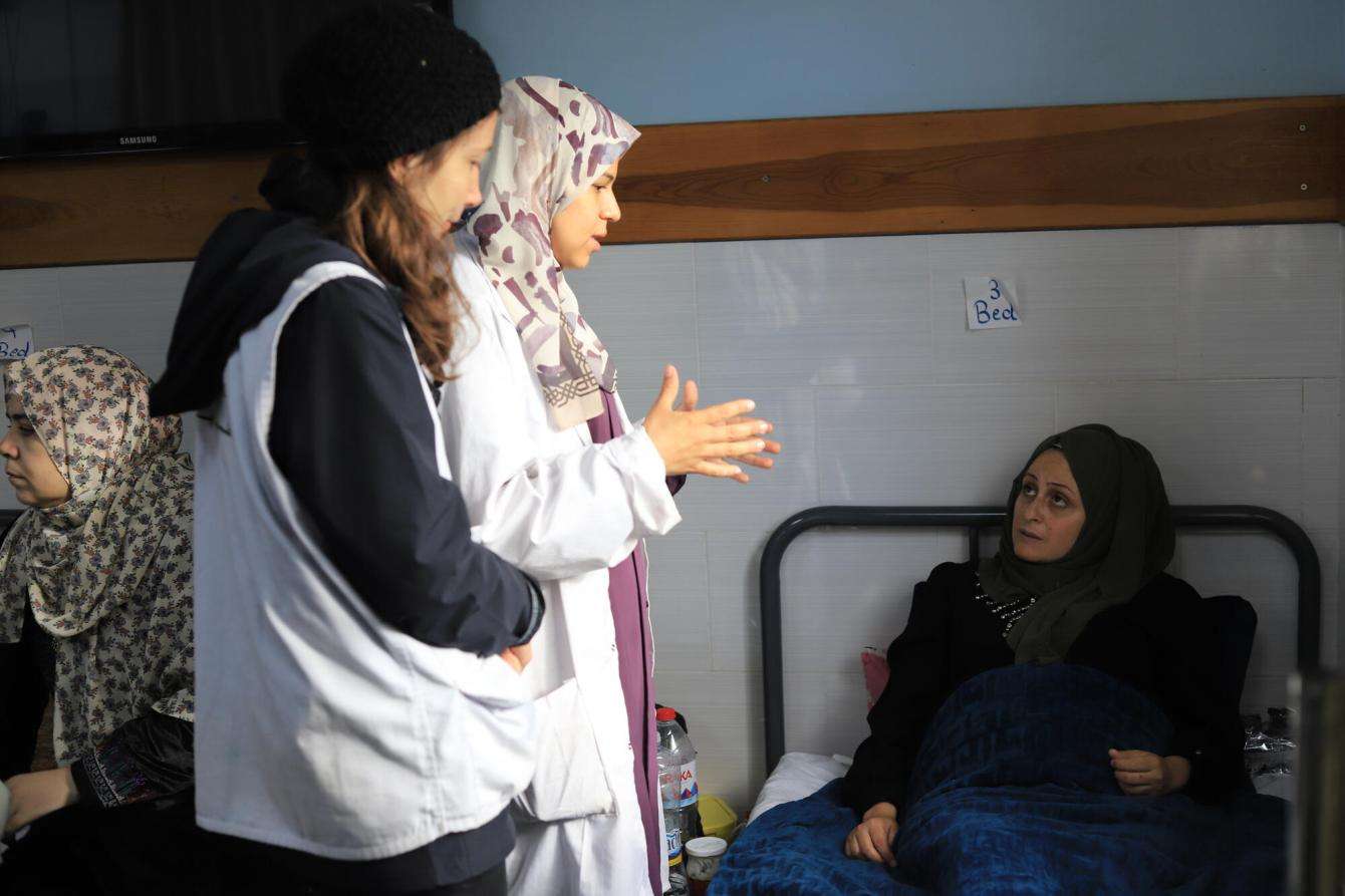 MSF team members speak with a pregnant patient at the Emirati Hospital, Rafah, southern Gaza.