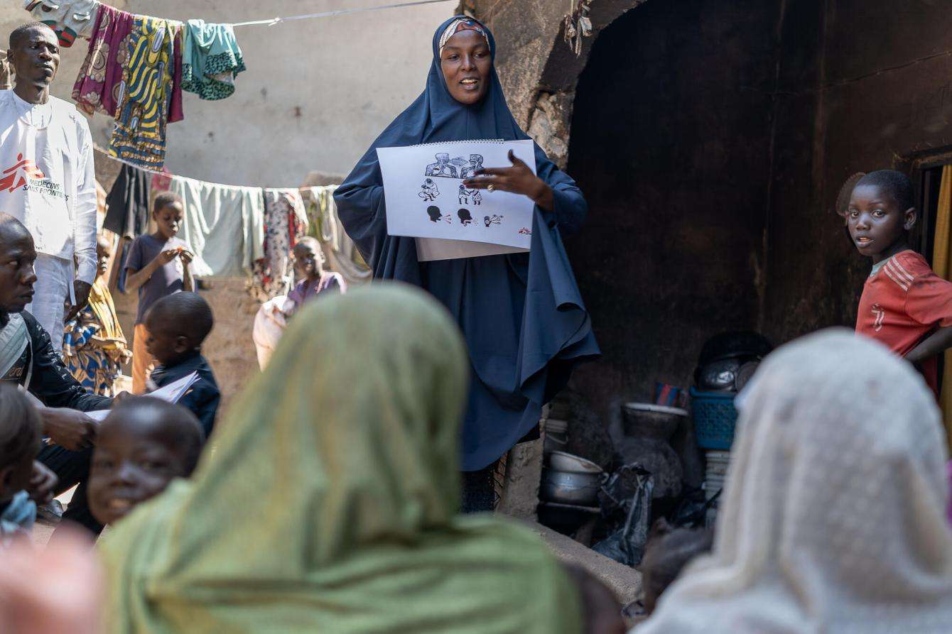 MSF Community Based Officer (CBO) provides essential information to a group of care givers in Gwange, Maiduguri. 