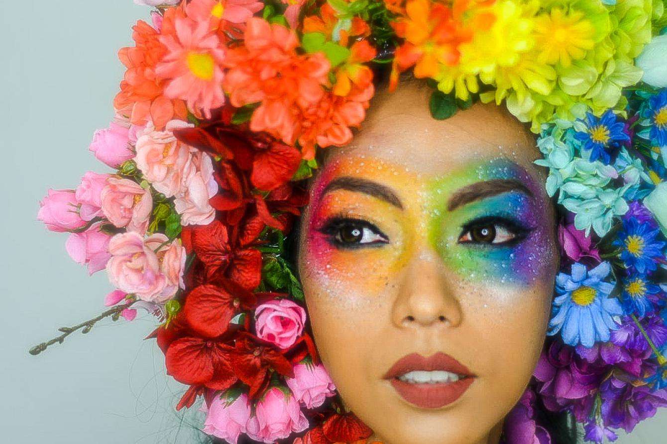 Julie Papango transgender woman with rainbow colored flowers 