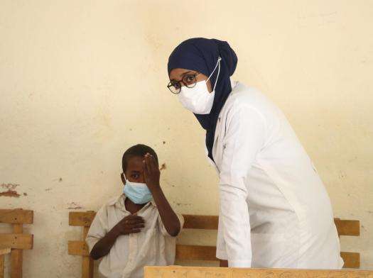 Optometrist Doctor Ms. Sagal Adam takes a patient through eye cover test to determine ocular misalignment during eye clinic exercise in Hudur town, Bakool region.