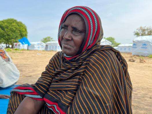 Sudanese woman sits on ground outside refugee camp in Central African Republic