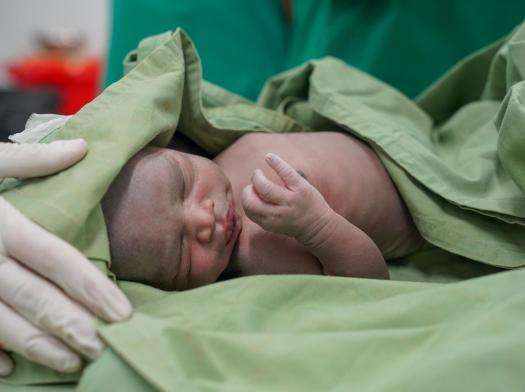 A newborn baby wrapped in a blanket in Kajo Keji, South Sudan.