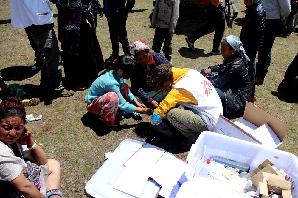 MSF mobile clinic team members distribute emergency supplies outside Kathmandu.