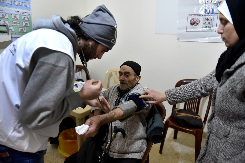MSF medical staff take a patient's vital signs. Photo by Abbass Salman/MSF 