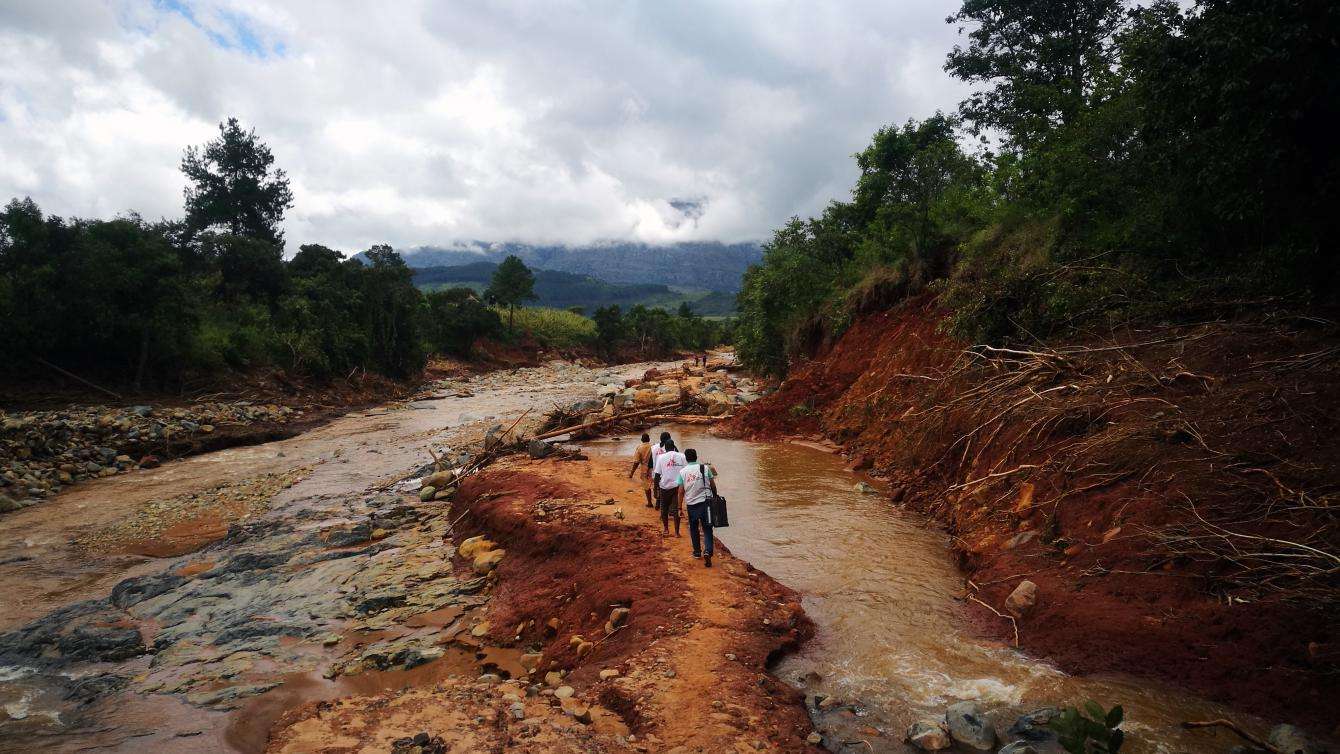An MSF mobile team walks to access a village cut off by damage caused by Cylone Idai in Chimanimani, Zimbabwe.