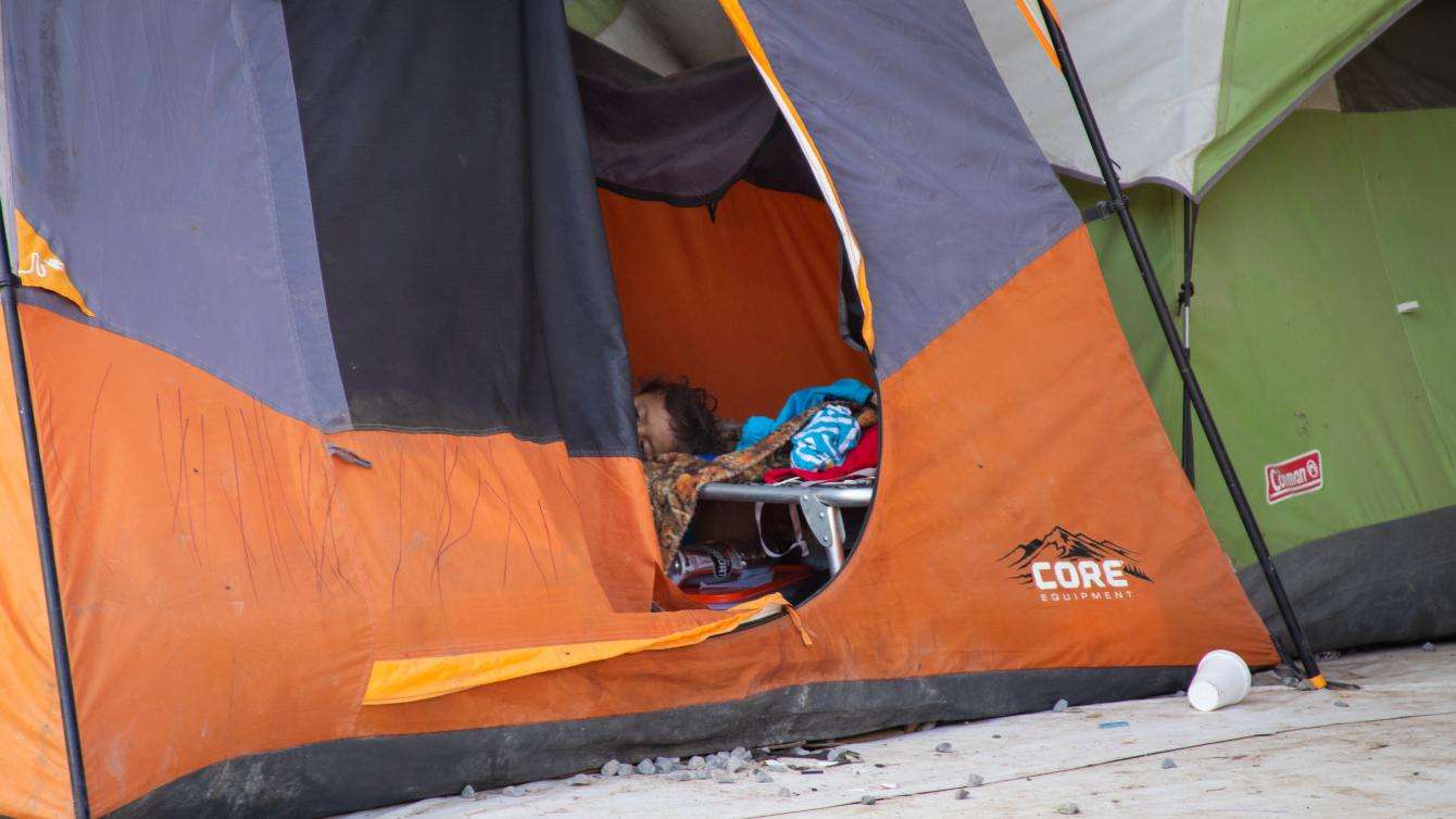 Children sleep in their tents during the day