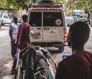Staff load a patient onto an ambulance at MSF's Turgeau Emergency Center in Port-au-Prince, Haiti