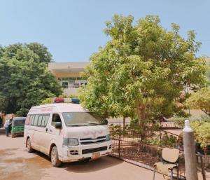 An ambulance parked by a tree outside MSF-supported Al Nao hospital in Omdurman, Sudan.
