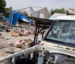 Destroyed MSF vehicle, and the bomb crater in the background