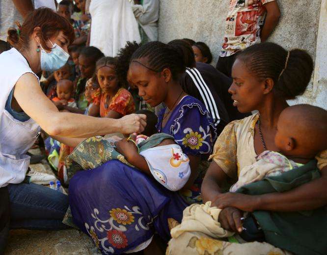 An MSF nurse screens a child for malnutrition at a mobile clinic in Adiftaw in 2021 in Tigray, Ethiopia.