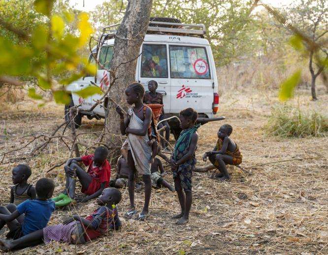 A group of children beside an MSF vehicle during health outreach activities in Boma, South Sudan.