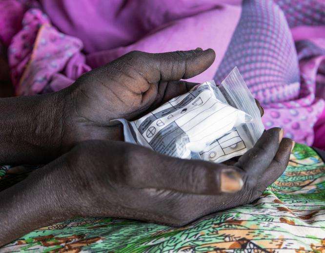 An HIV/TB patient holds medication in South Sudan. 