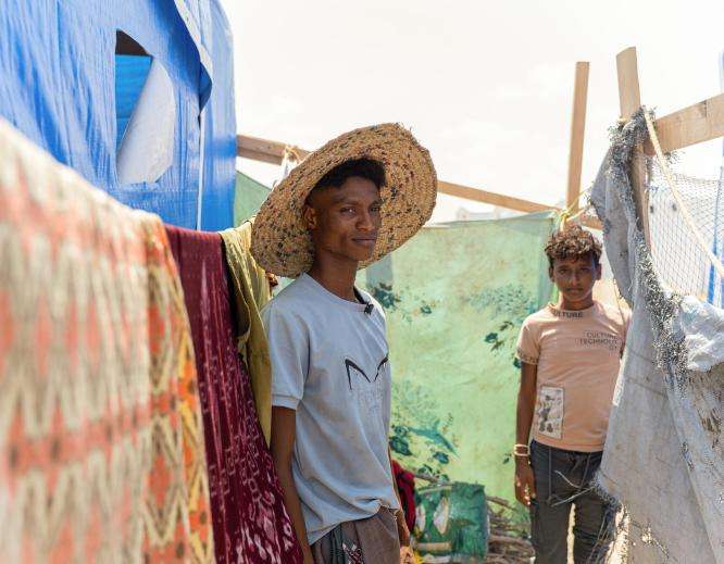 Displaced men in a camp in Yemen.