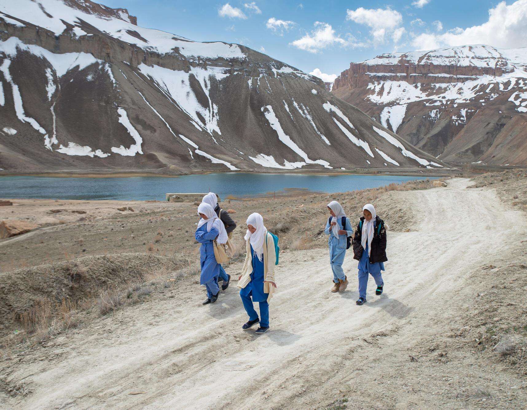 Girls walk to school with mountains of Bamyan province, Afghanistan in the background.
