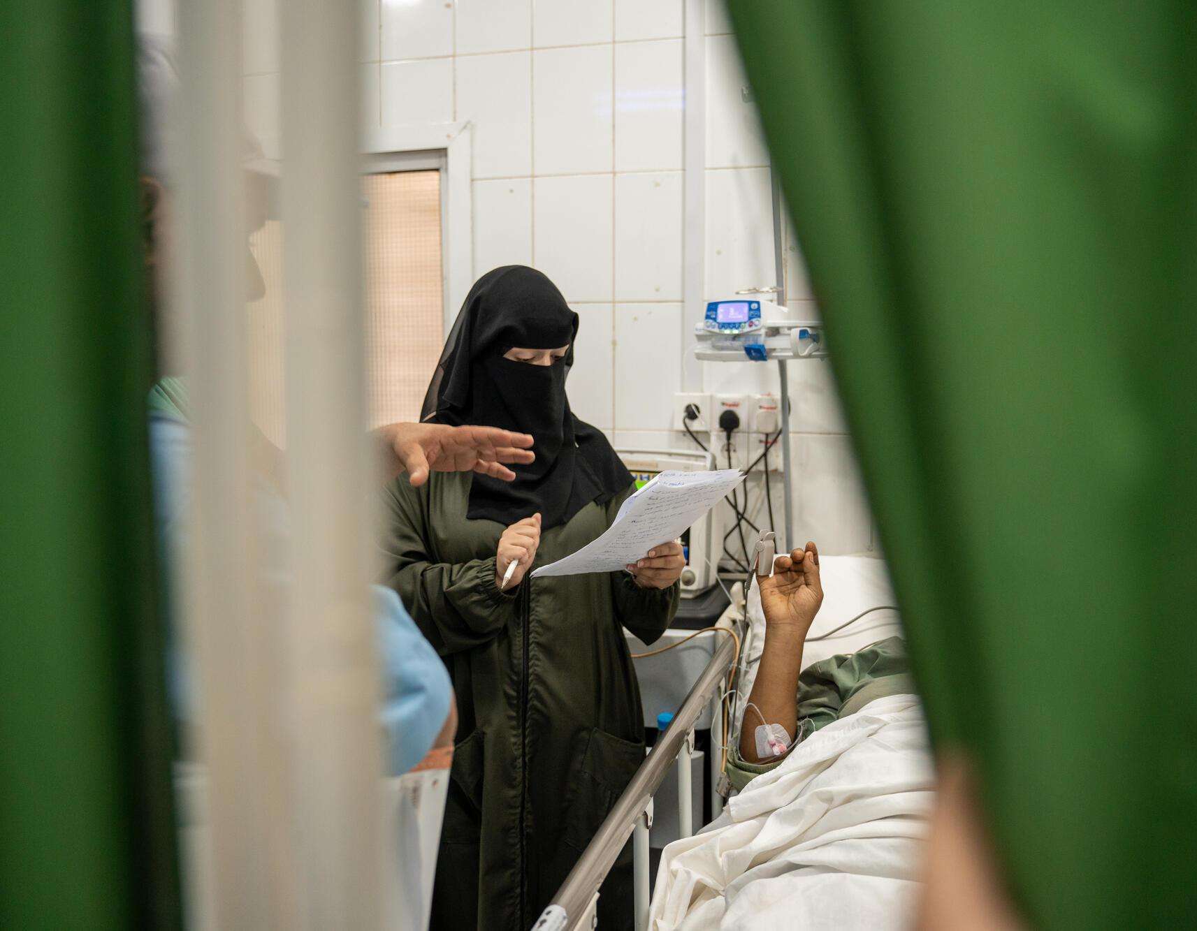  Dr. Reem checks on patients in the intensive care unit at Mokha Hospital.