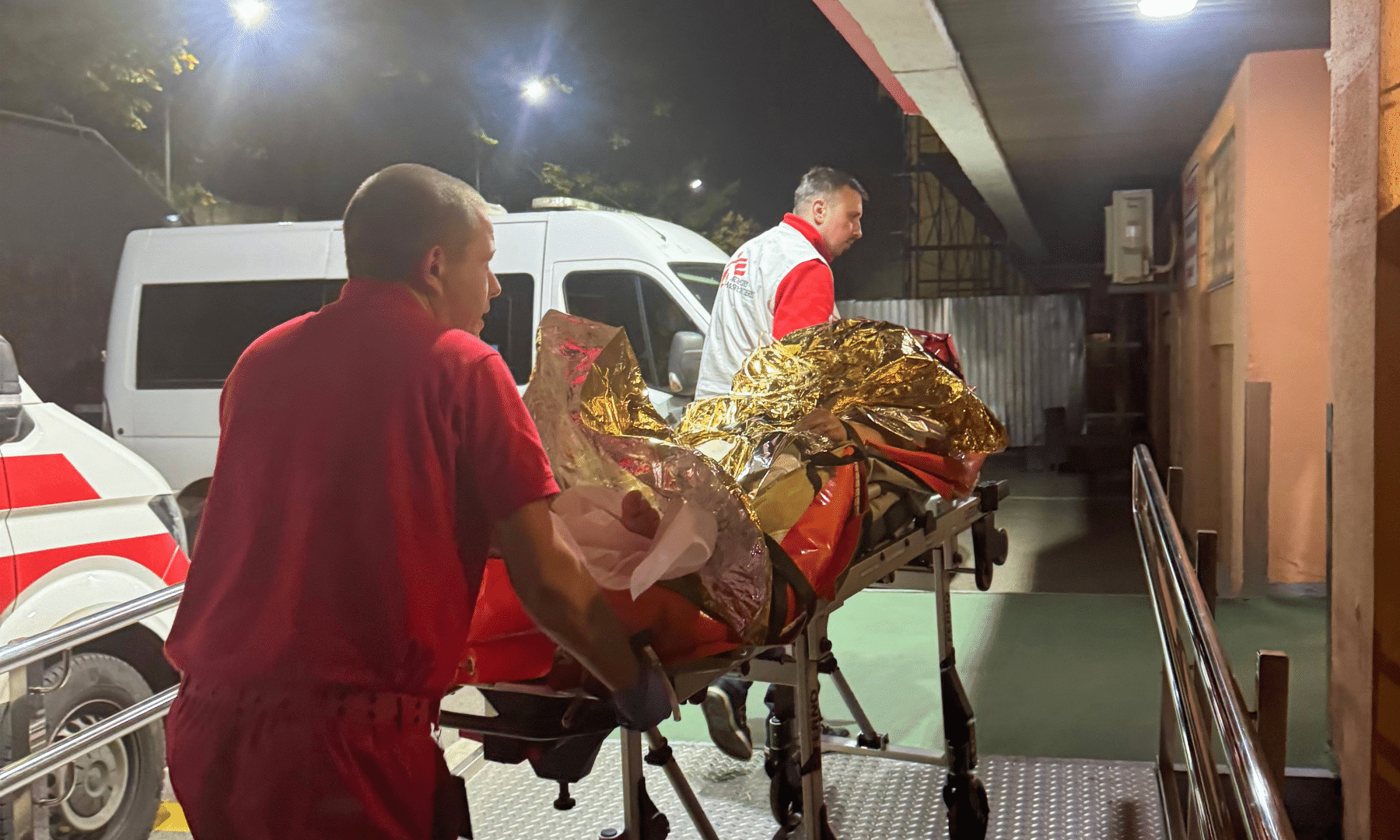 MSF teams transport a patient on a stretcher after a Russian attack on Ukraine.