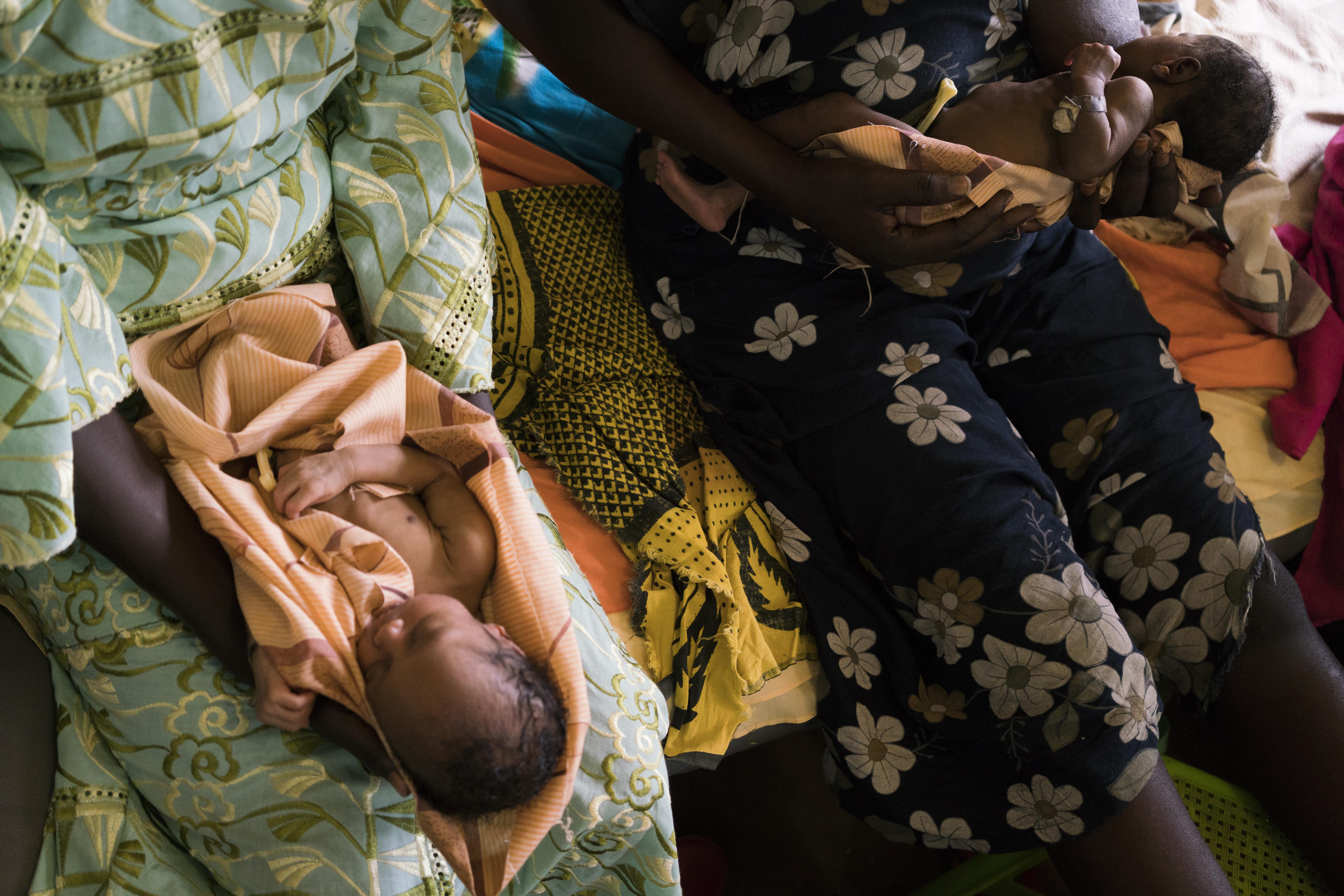 Twins are held on the bed in the maternity ward of the MSF hospital in Aweil, South Sudan.  