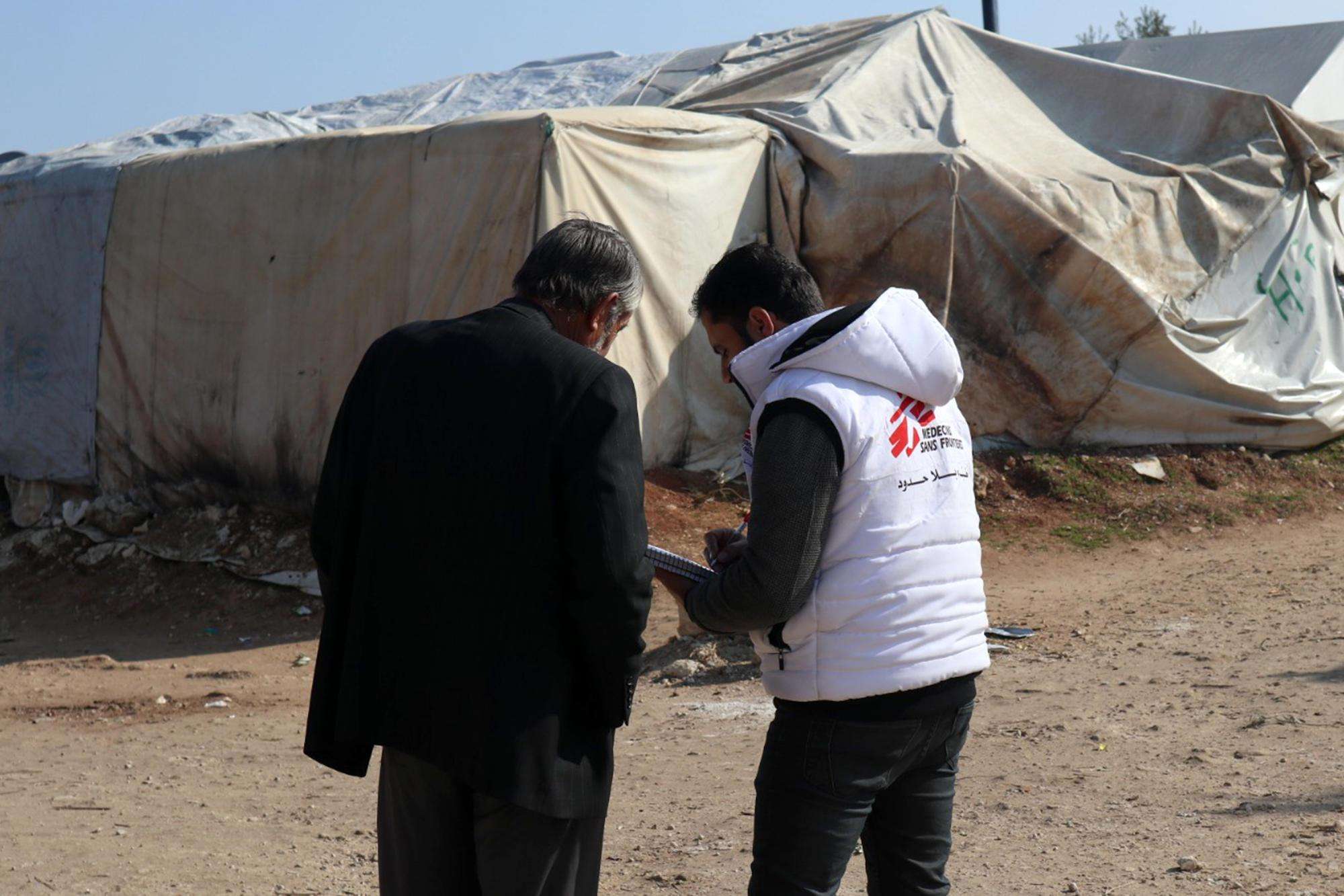 An MSF health worker talks with a Syrian man in Qadimoon camp.