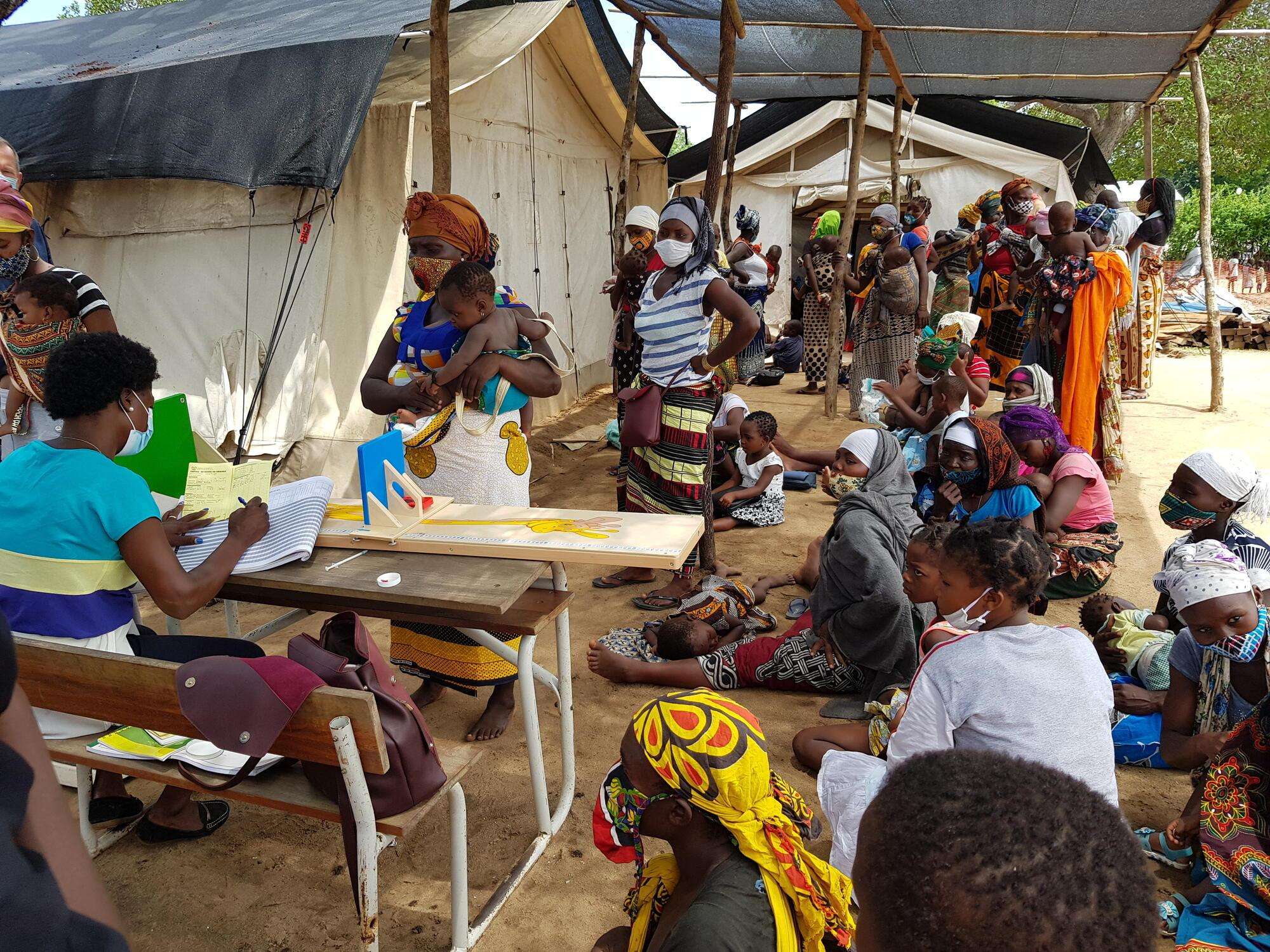 Women and children in line at a mobile clinic 
