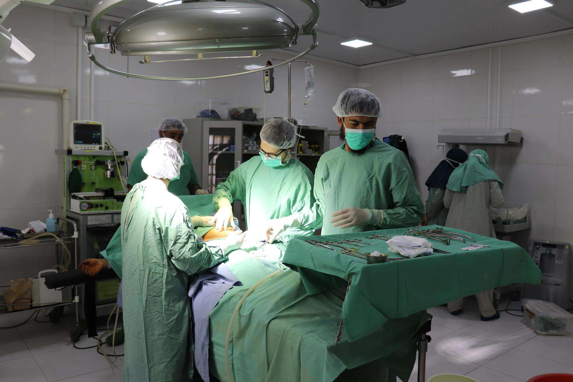 A medical team prepares to begin a surgery in the operating theater of Boost hospital, Lashkar Gah, Afghanistan.