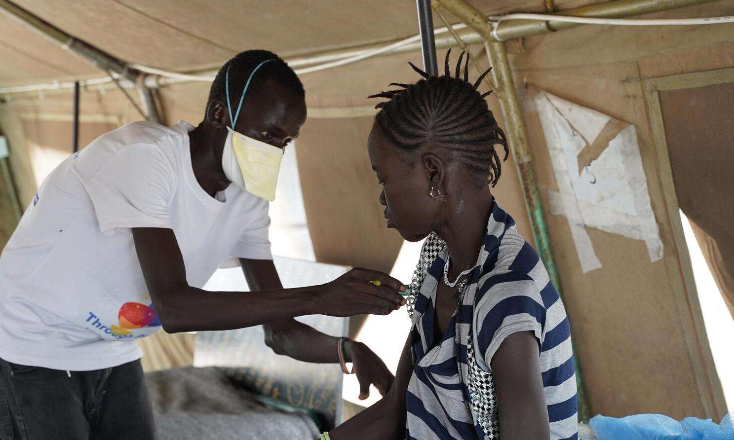 MSF nurse examines a patient