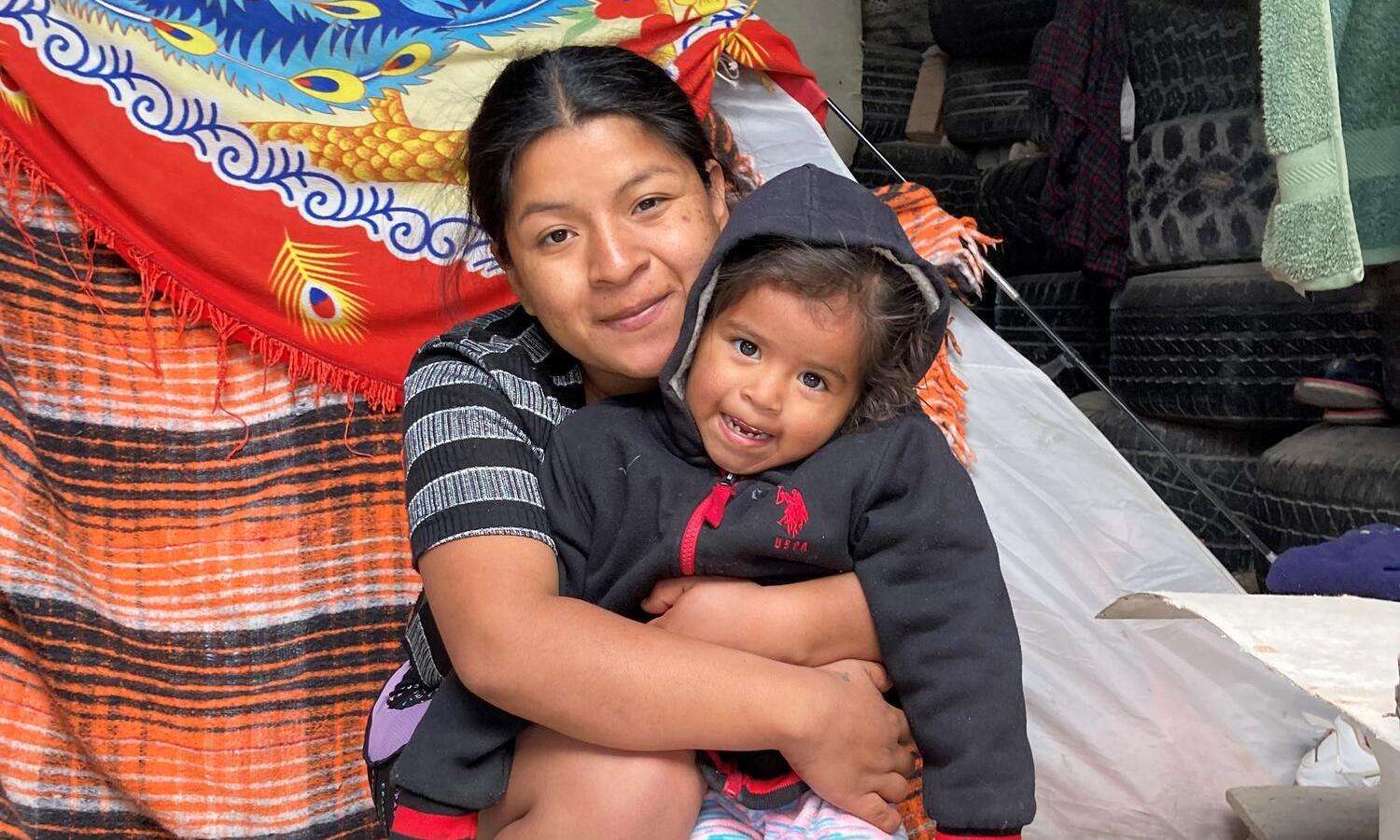 A woman hugs her child in Mexico after migrating from Honduras.