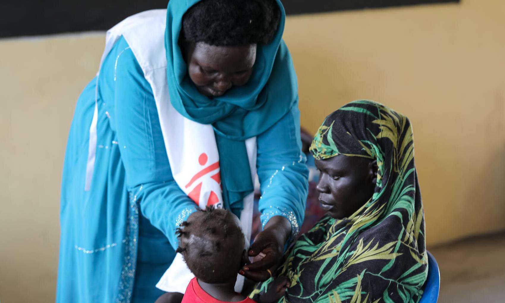 An MSF medic treats a small child at a mobile clinic in Renk, Upper Nile state.
