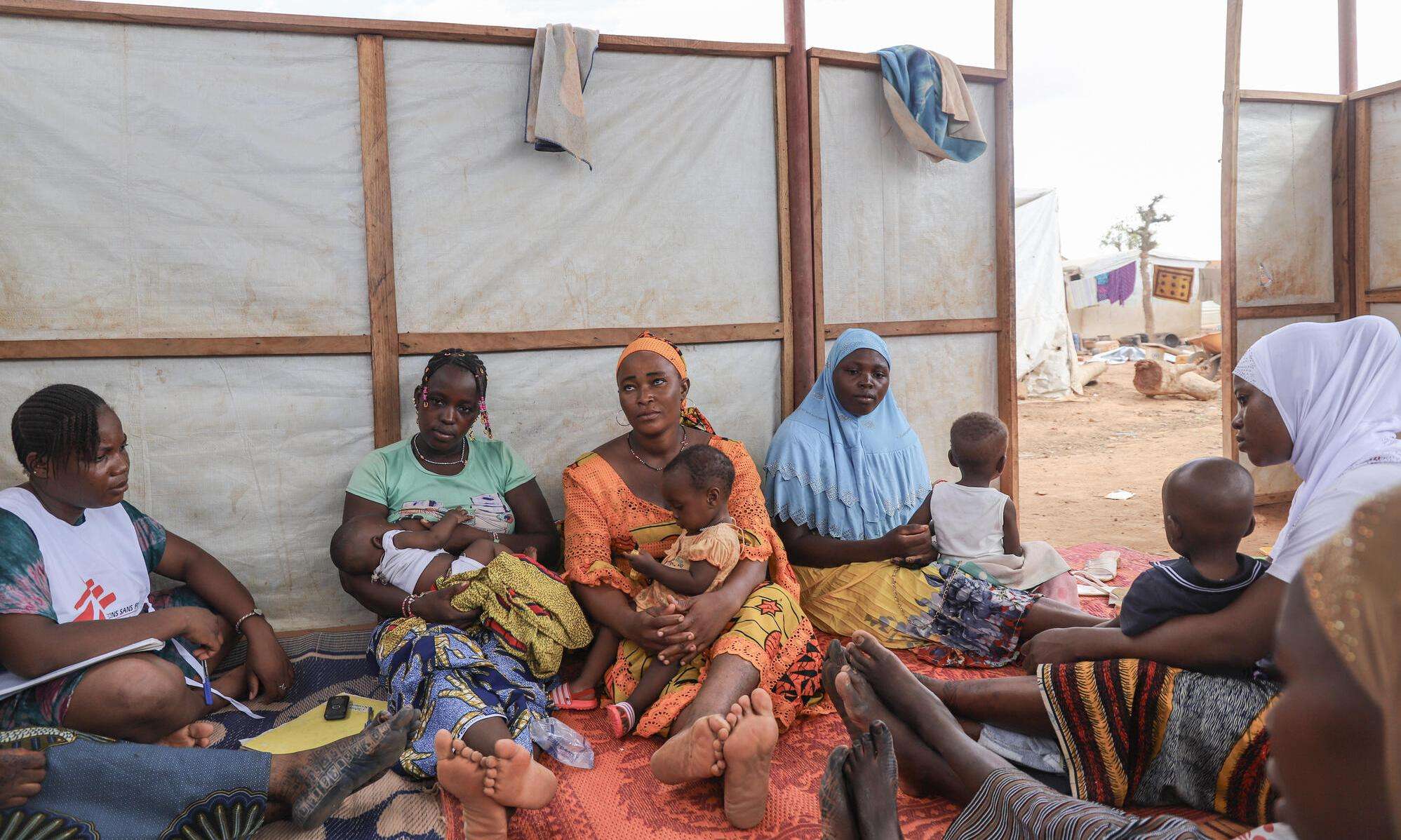 Mothers and their children in a women's club session in an IDP camp in Kongoussi, Burkina Faso