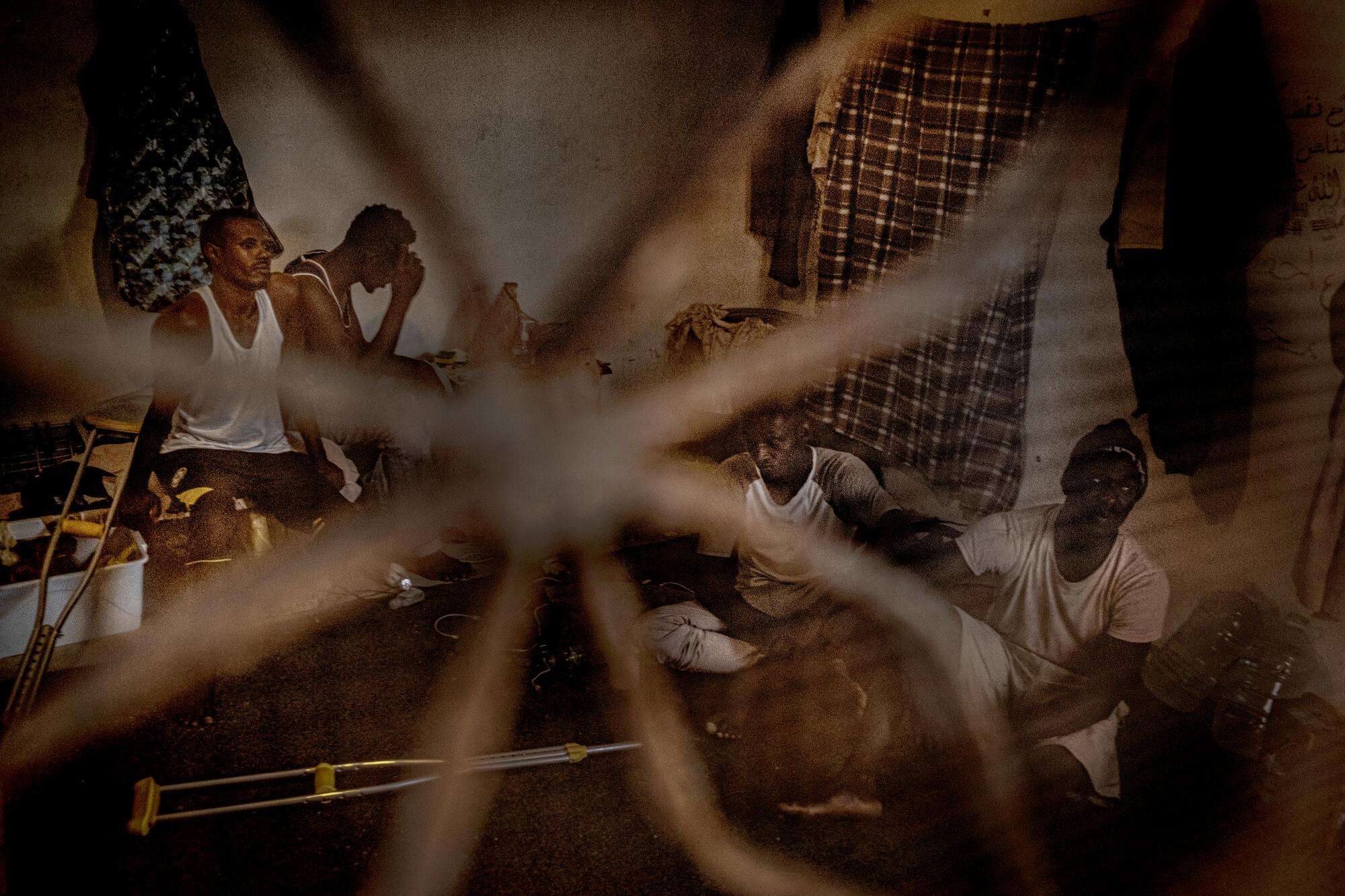 A group of migrants and refugees gathered together in a shared dwelling in Libya in August 2021.