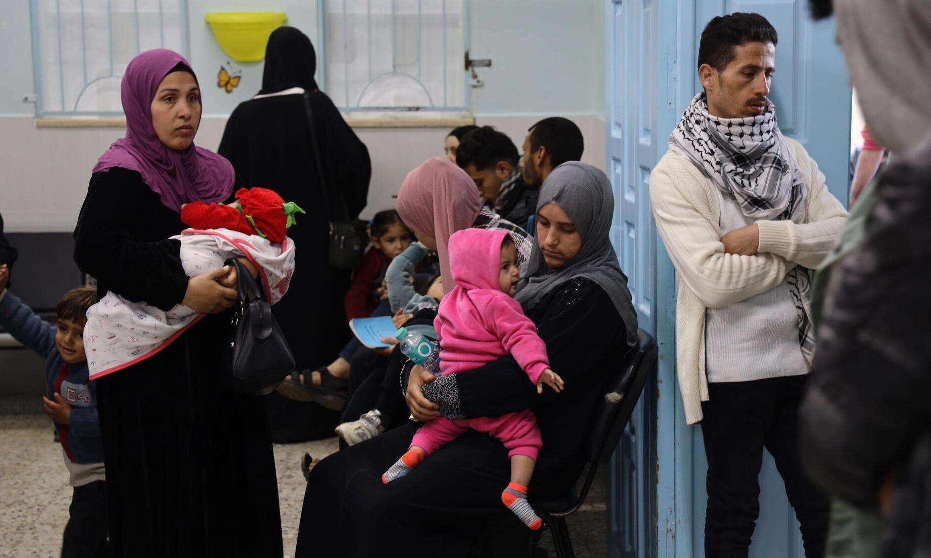 Patients wait for care inside the Al-Shaboura clinic in Rafah, Gaza.