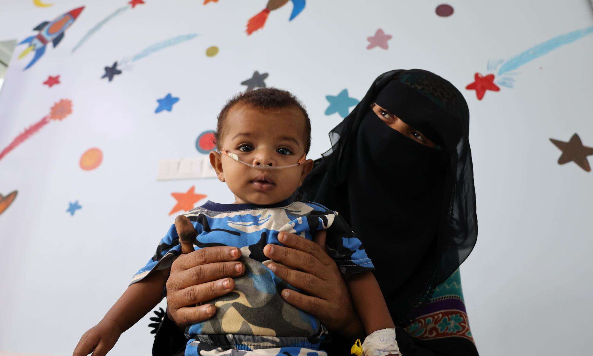 Karima holds her 6-month-old son Ahmed, who is receiving treatment at Al-Qanawis Mother and Child Hospital in Al-Hudaydah governorate, Yemen.