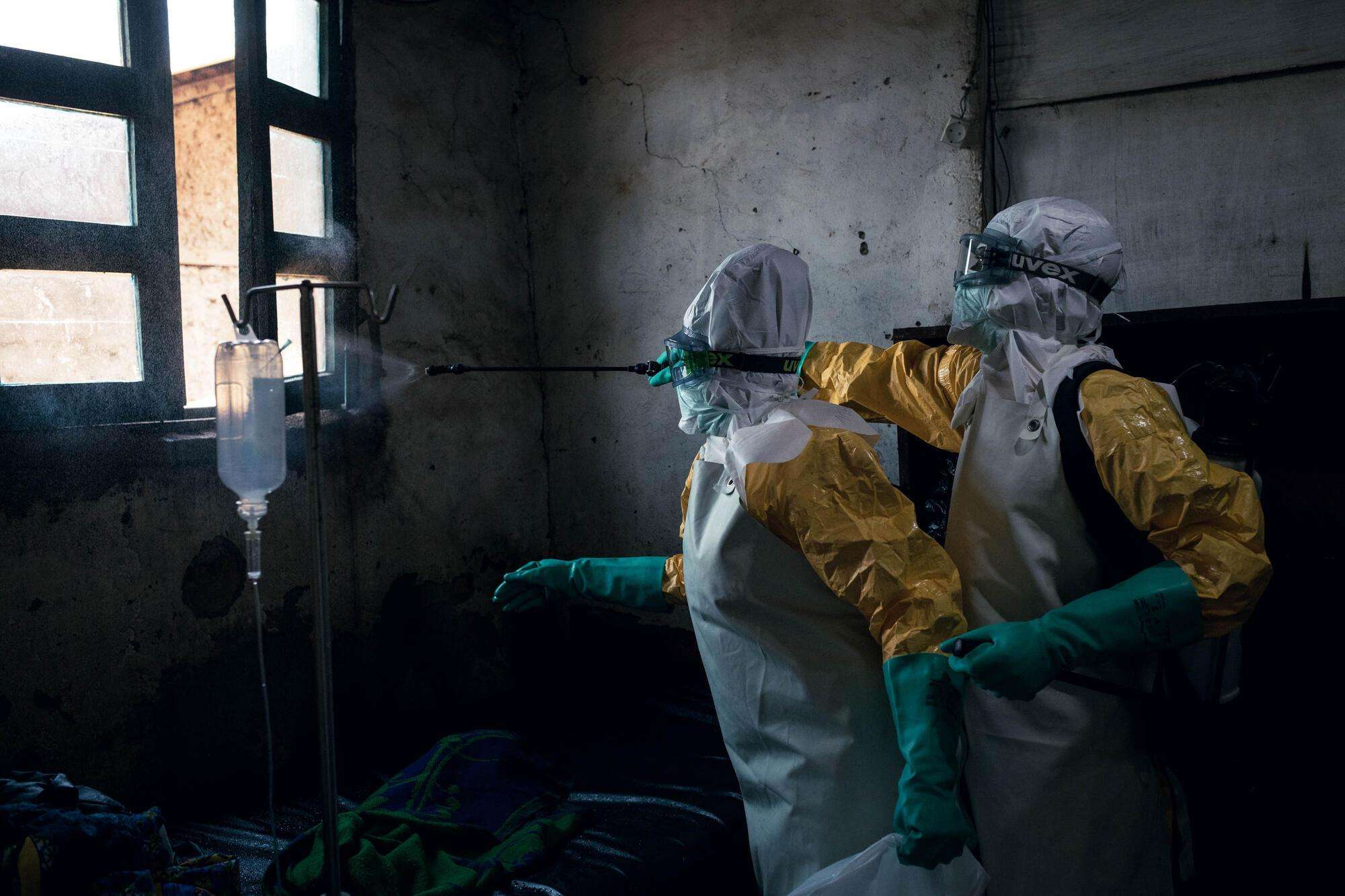 MSF hygienists disinfect a room at Sayo Health Center in Mongbwalu after it was occupied by a patient with confirmed Ebola disease.