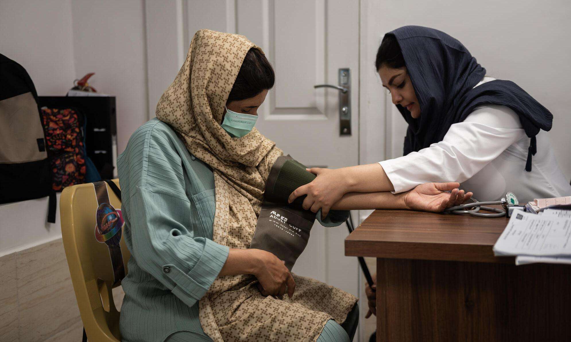 A doctor checks a pregnant woman's blood pressure at the MSF-run Mehr clinic in southwest Tehran, where vulnerable people, including refugees and others, can access free health care.