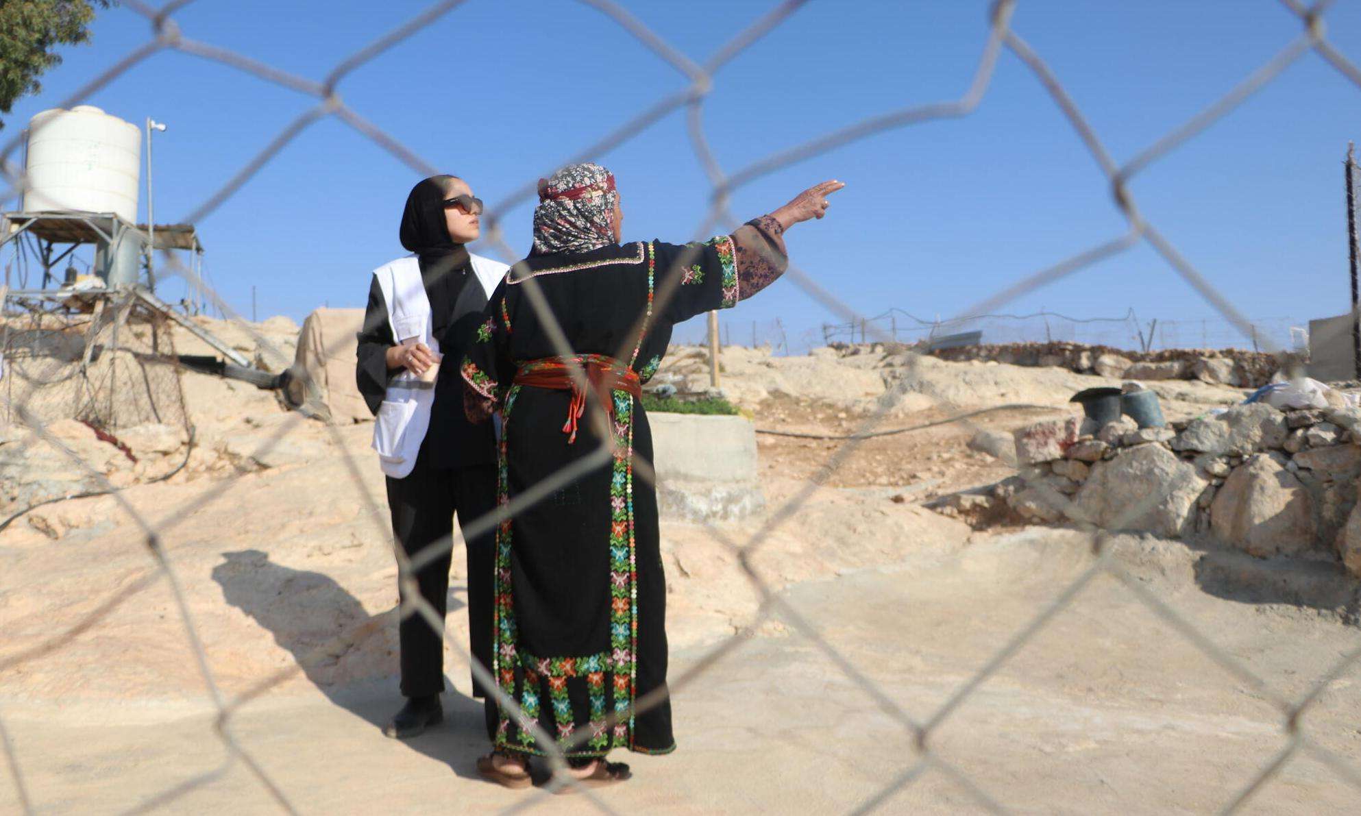 An MSF workers assists an eldery woman in the West Bank, Palestine. 