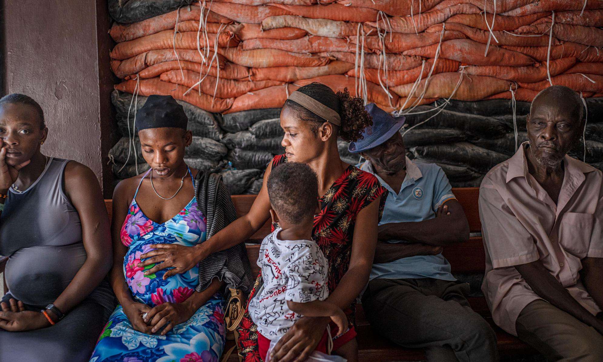 A pregnant woman waits to be seen at a clinic in Haiti. 
