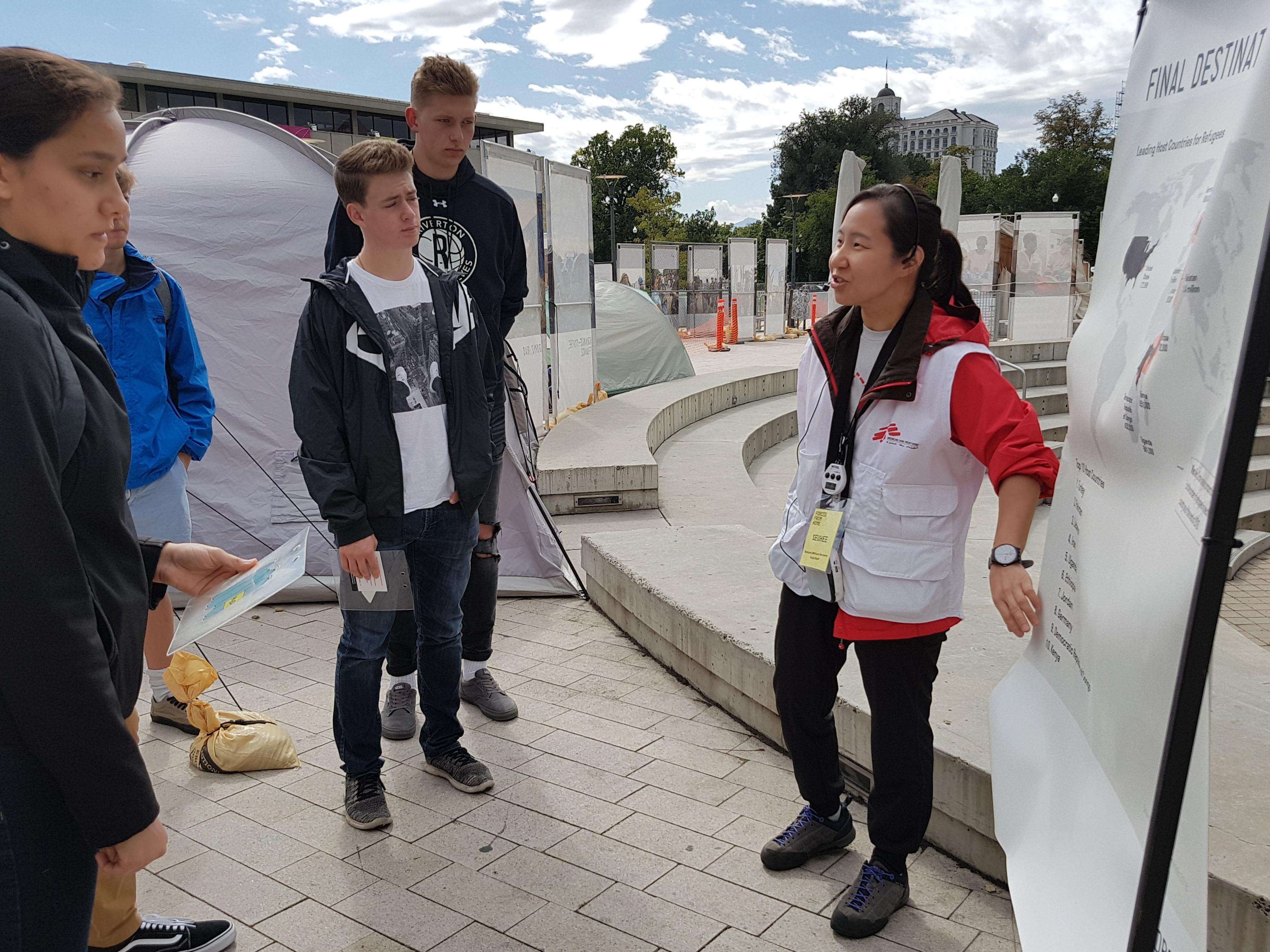 Dr. Seuhee Yoo leads a student group through the Forced From Home exhibition in Library Square, located in downtown Salt Lake City