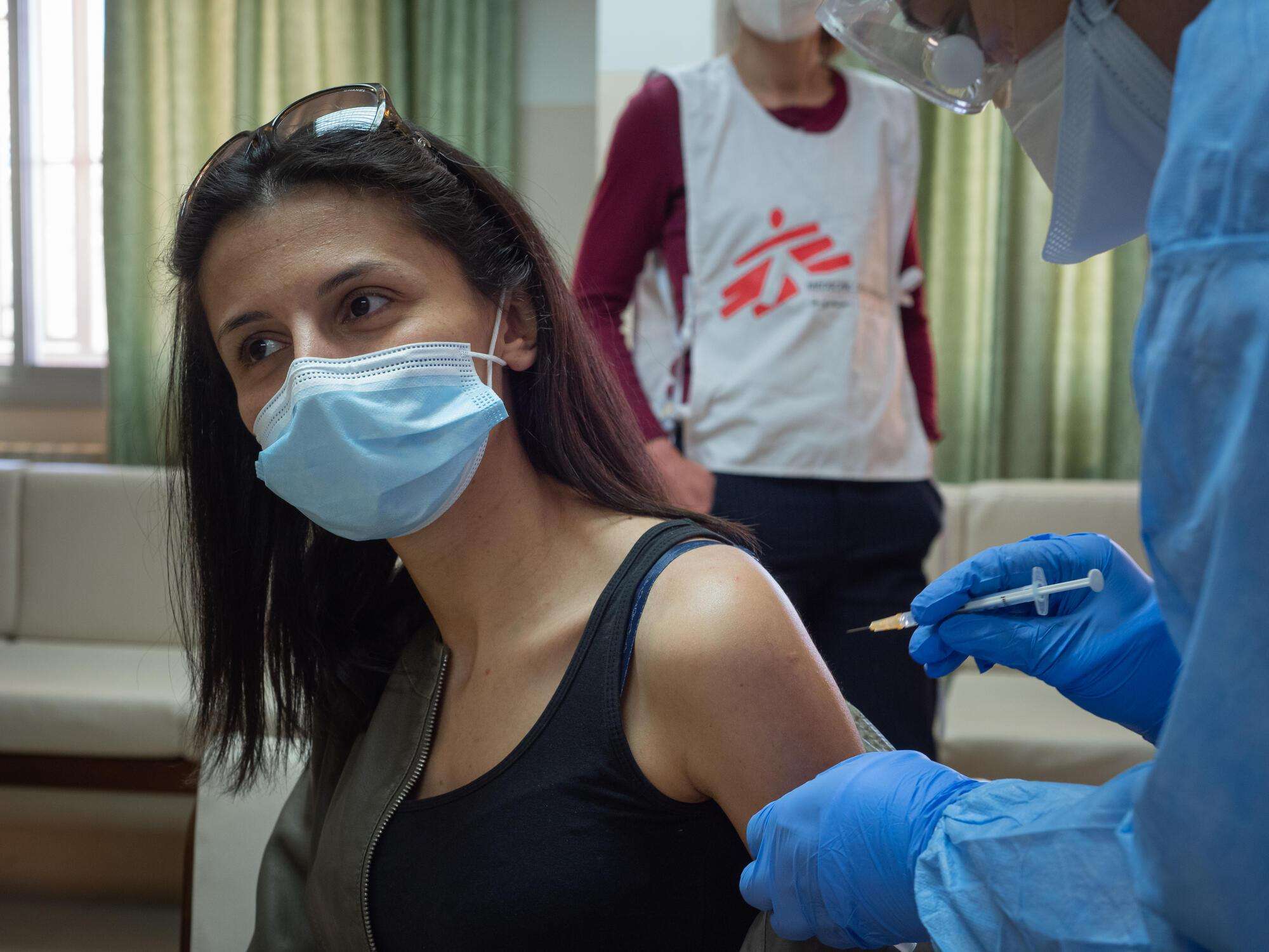 A frontline health worker at a nursing home In Chlifa Baalbak, Lebanon, receives a COVID-19 vaccine supplied by the Lebanese Ministry of Public Health and administered by an MSF medical team.