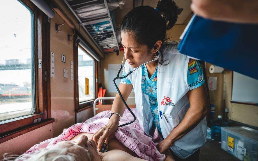 Dr. Guadalupe Garcia Noria monitors a patient inside the inpatient department of the MSF medical team during a journey from Pokrovsk, eastern Ukraine to Lviv, in western Ukraine.