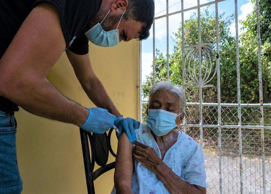 Rolando Betancourt of Puerto Rico Salud vaccinates a resident of Humacao on the eastern coast of Puerto Rico.