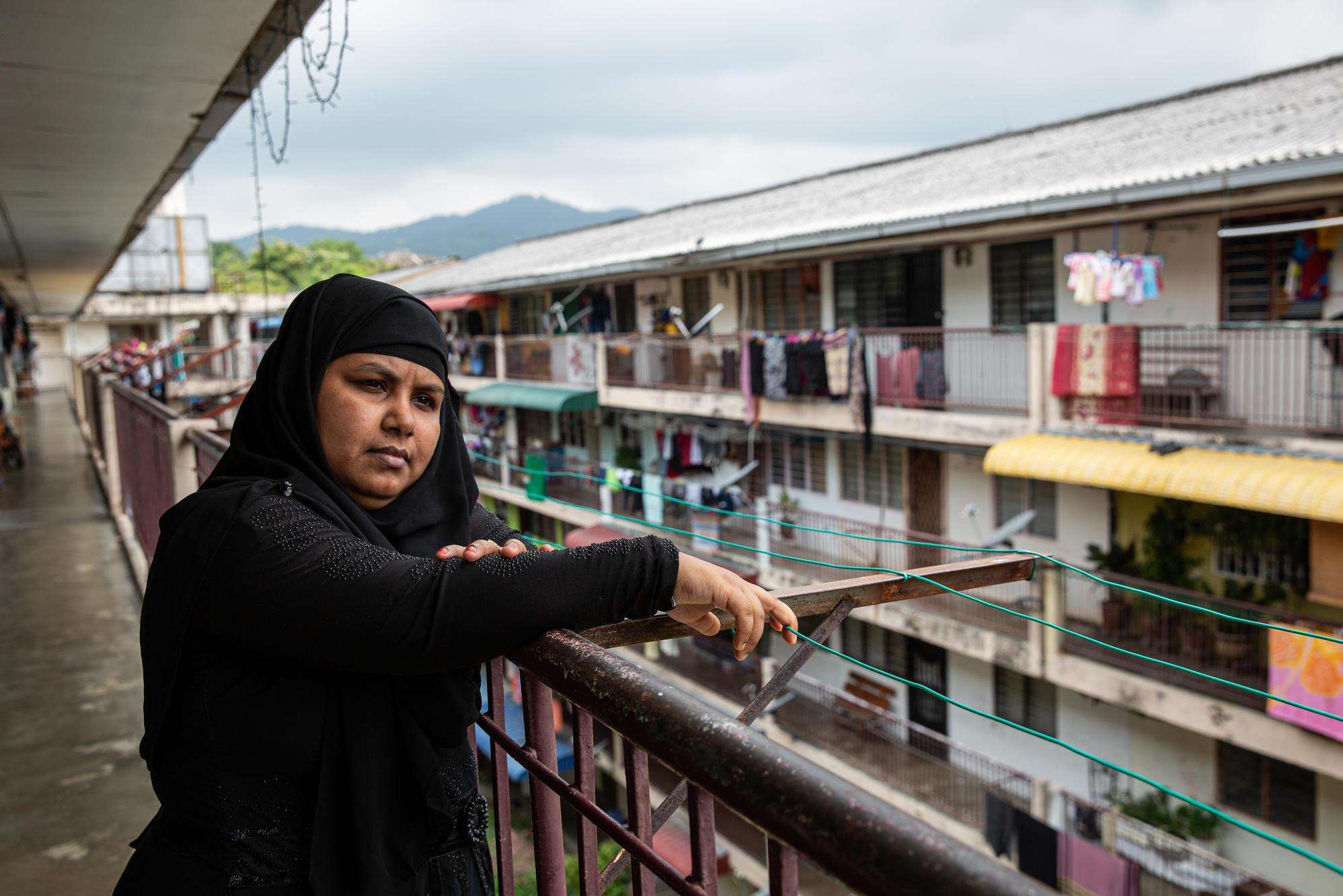 A Rohingya woman on a balcony in Penang, Malaysia.