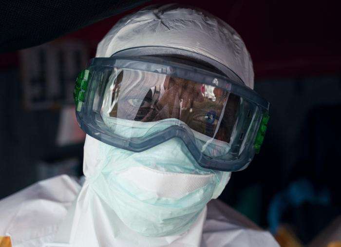 A staff member puts on personal protective equipment (PPE) at MSF's Ebola treatment center at Elikya Hospital Center in Bunia, Ituri province, DR Congo.